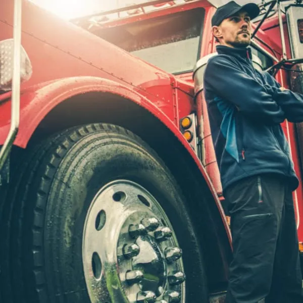 truck driver next to semi truck truck driver next to semi truck